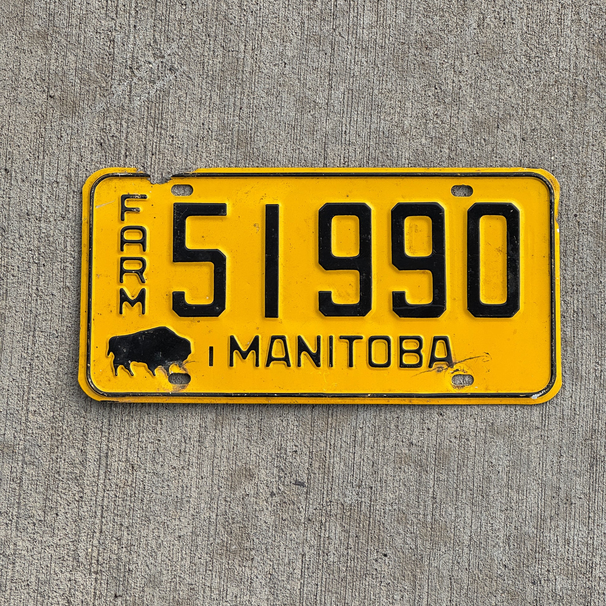 Photo of a 1964 Manitoba Farm Truck License Plate Auto Tag Garage Decor Vintage Front Plate 51990 with original patina