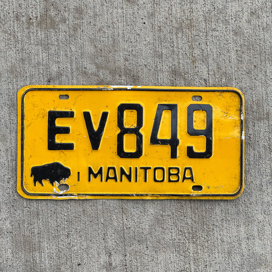 Photo of a 1964 Manitoba License Plate Auto Tag Garage Decor Vintage Buffalo Bison EV 849 with original patina
