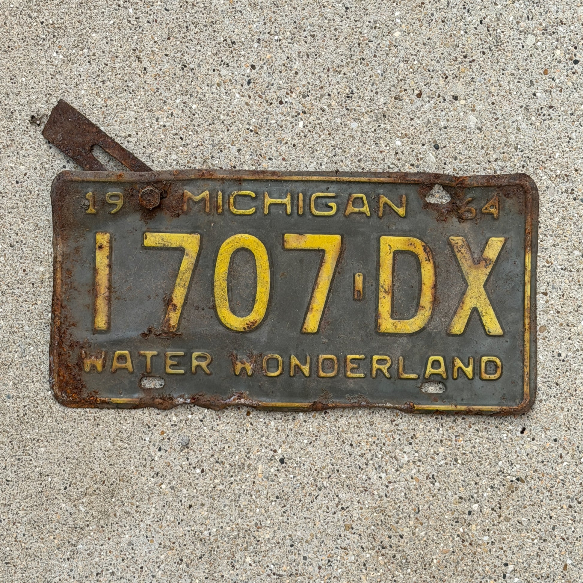 Photo of a 1964 Michigan Commercial License Plate Auto Tag Garage Decor Vintage 1707 DX with original patina