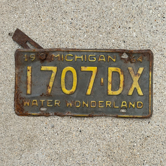 Photo of a 1964 Michigan Commercial License Plate Auto Tag Garage Decor Vintage 1707 DX with original patina