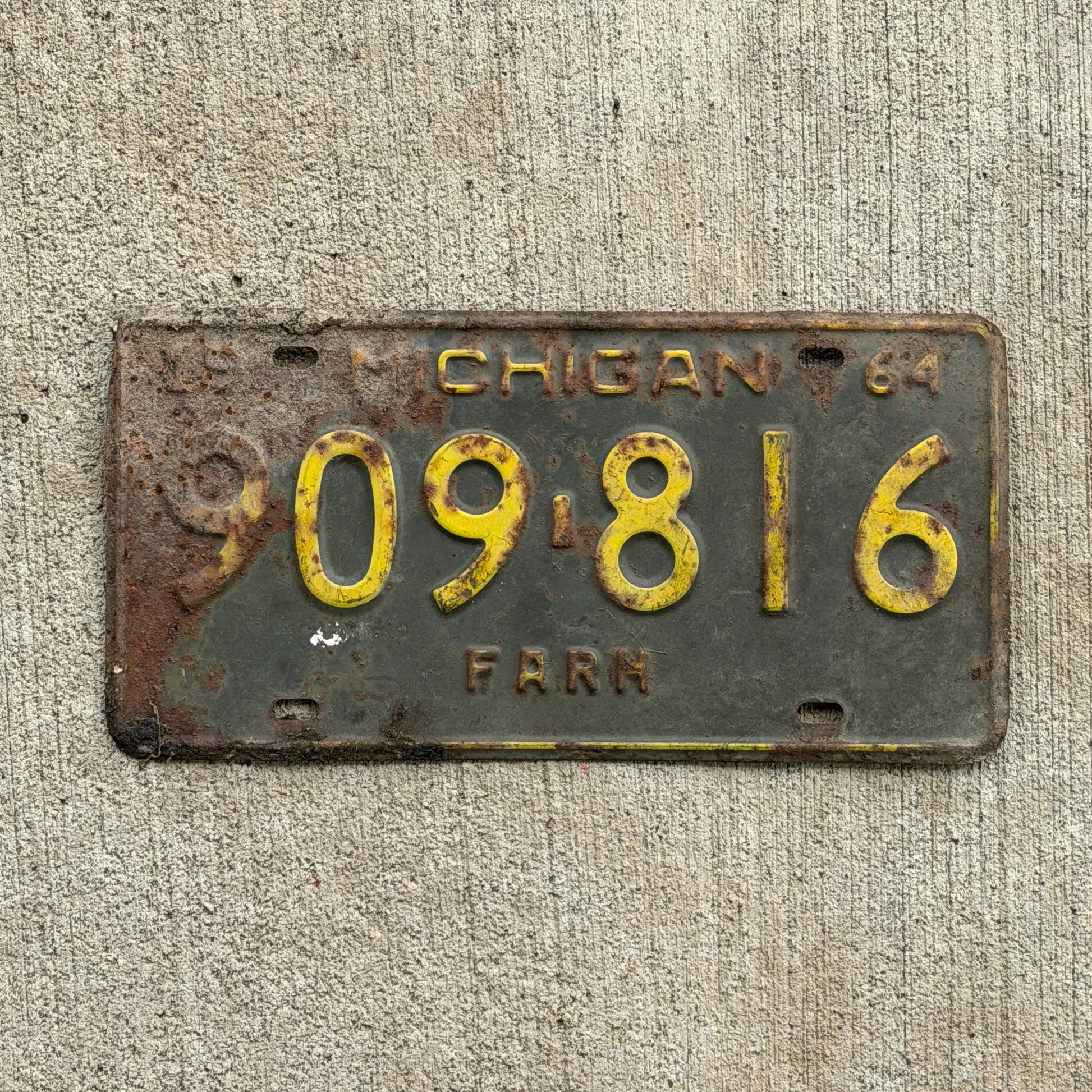 Photo of a 1964 Michigan Farm License Plate Auto Tag Garage Decor Vintage 909 816 with original patina