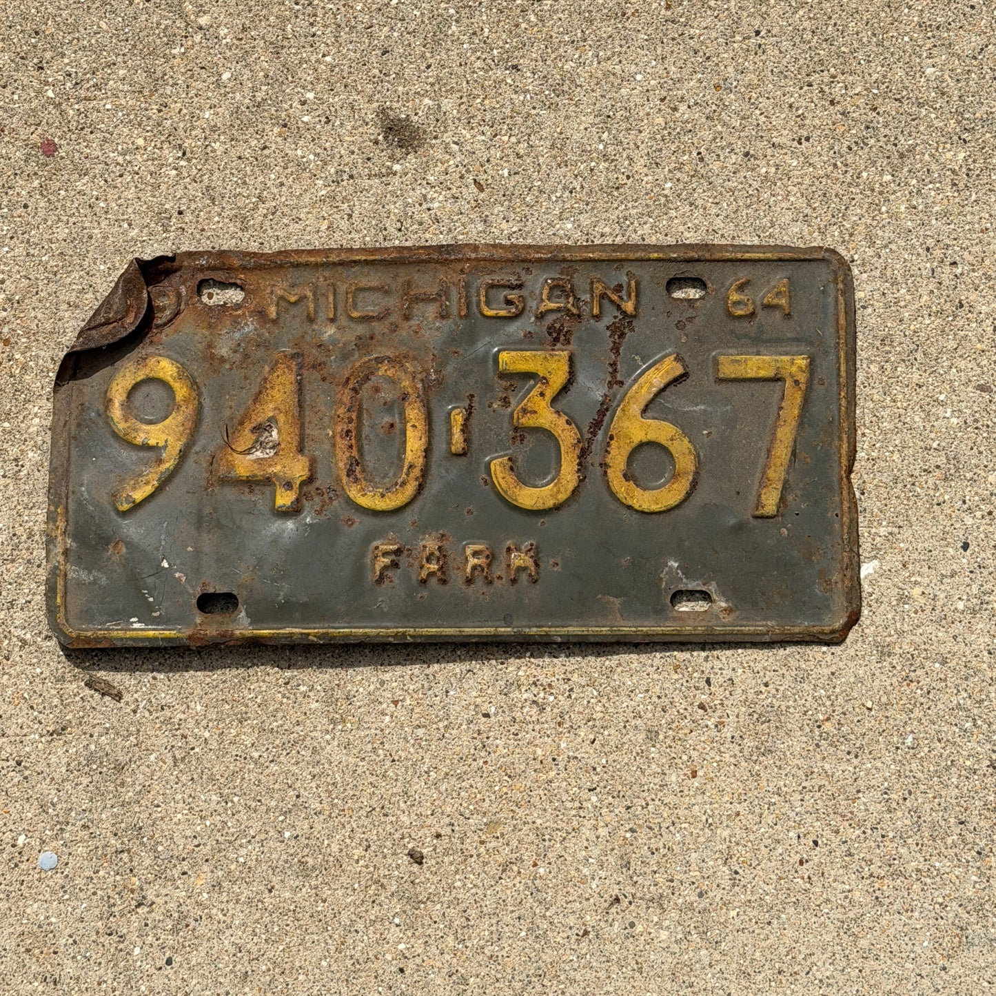Photo of a 1964 Michigan Farm License Plate Auto Tag Garage Decor Vintage 940 367 with original patina