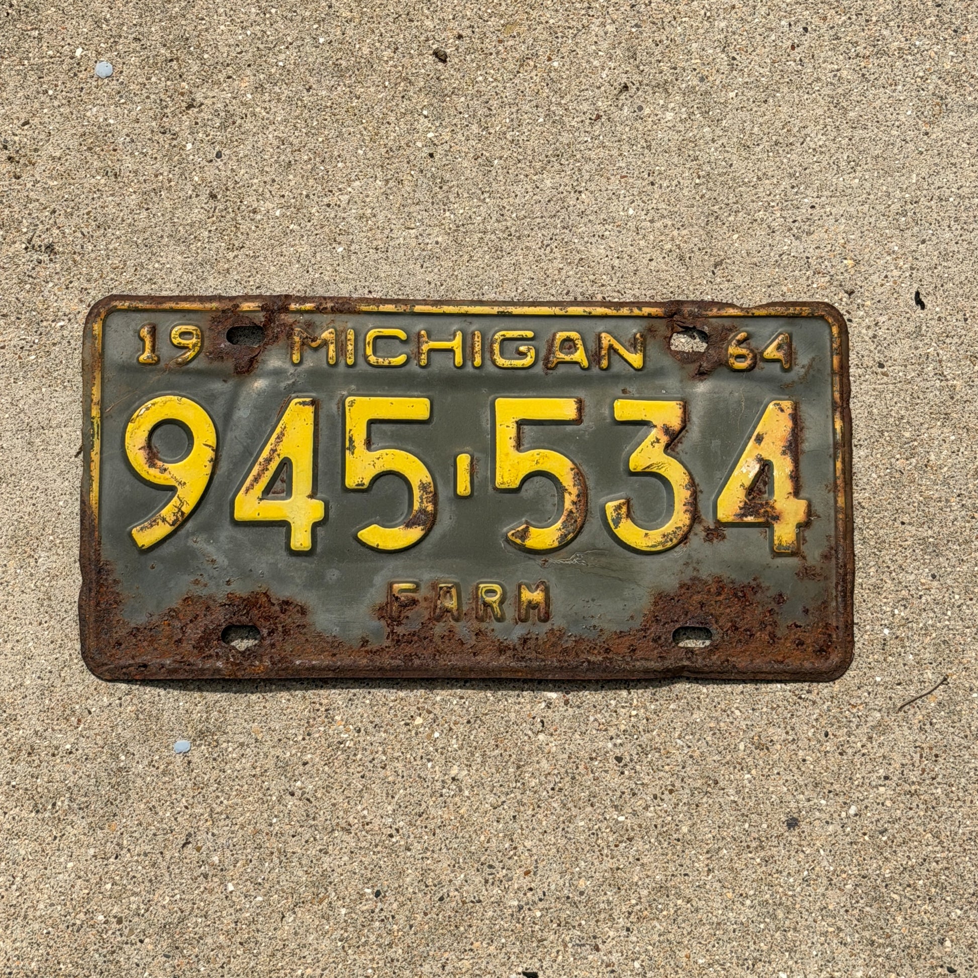 Photo of a 1964 Michigan Farm License Plate Auto Tag Garage Decor Vintage 945 534 with original patina