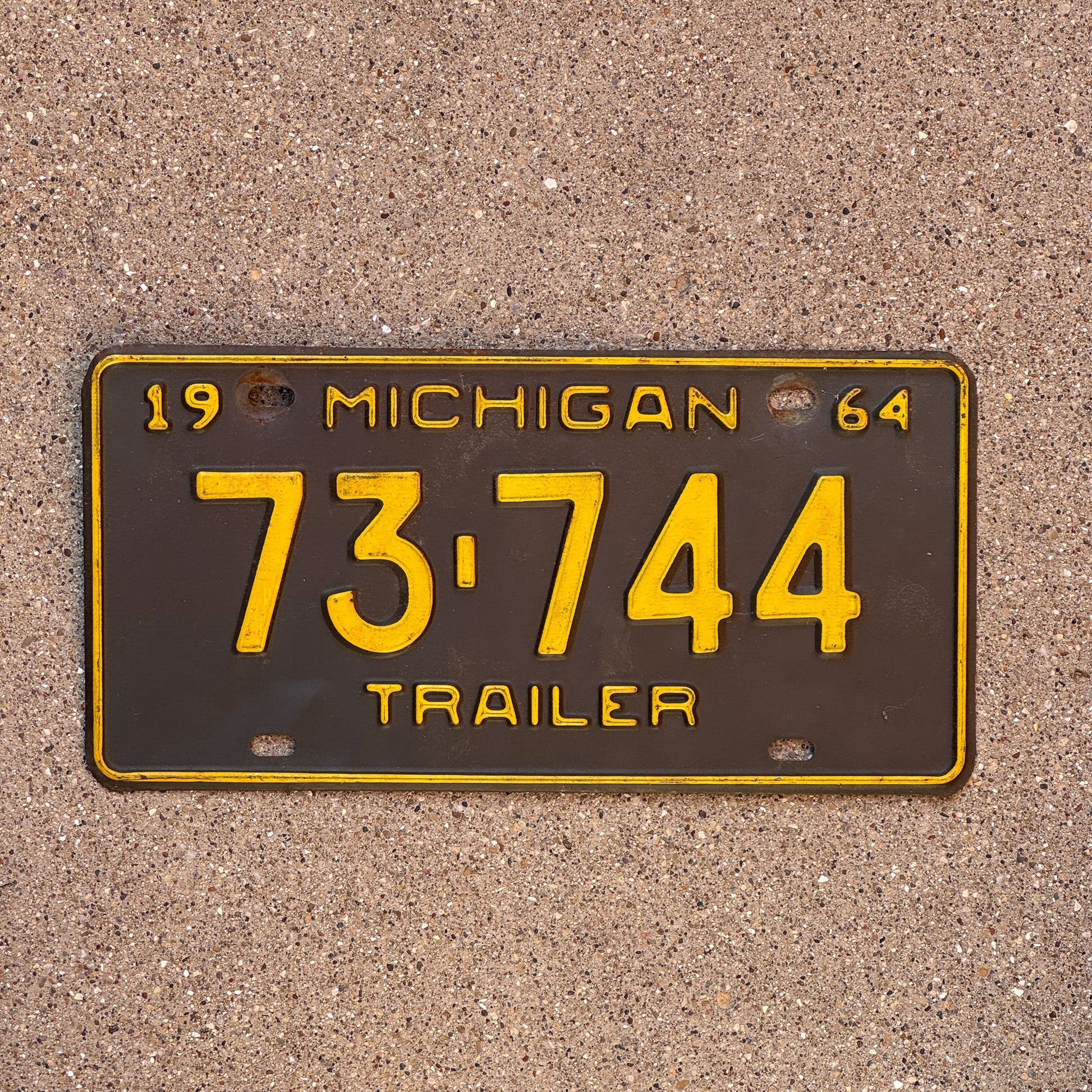 Photo of a 1964 Michigan Trailer License Plate Auto Tag Garage Decor Vintage 73 744