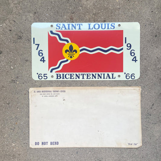 Photo of a 1964 Missouri Booster License Plate Auto Tag Garage Decor Vintage With Envelope SAINT LOUIS BICENTENNIAL with original patina