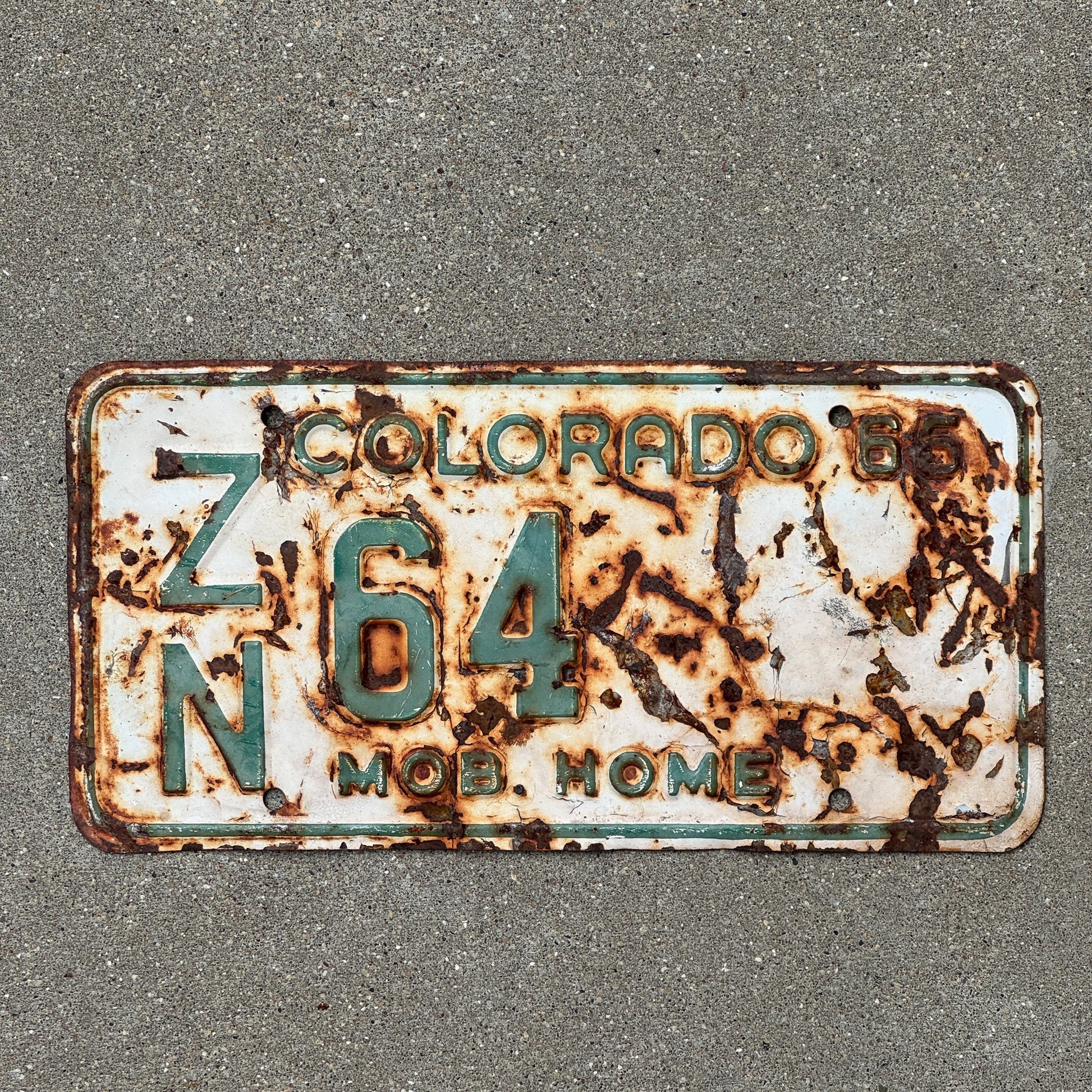Photo of a 1965 Colorado Mobile Home License Plate Auto Tag Garage Decor Vintage ZN 64