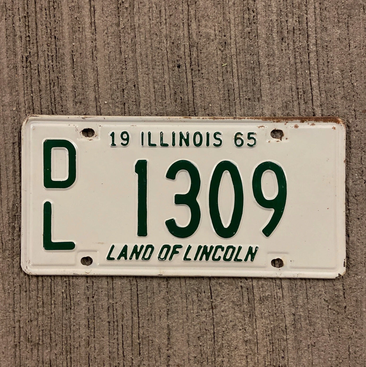 Photo of a 1965 Illinois Dealer License Plate Auto Tag Garage Decor Vintage 1309 with original patina