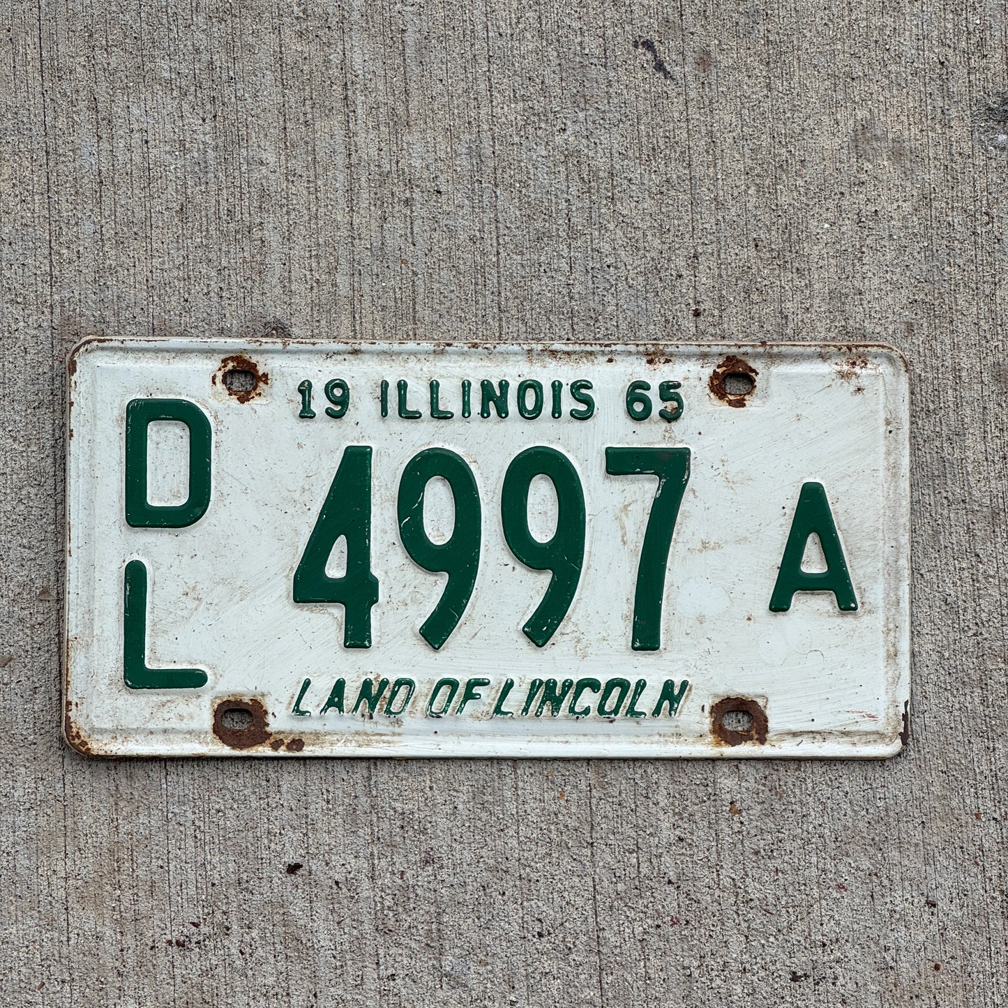 Photo of a 1965 Illinois Dealer License Plate Auto Tag Garage Decor Vintage 4997 A with original patina