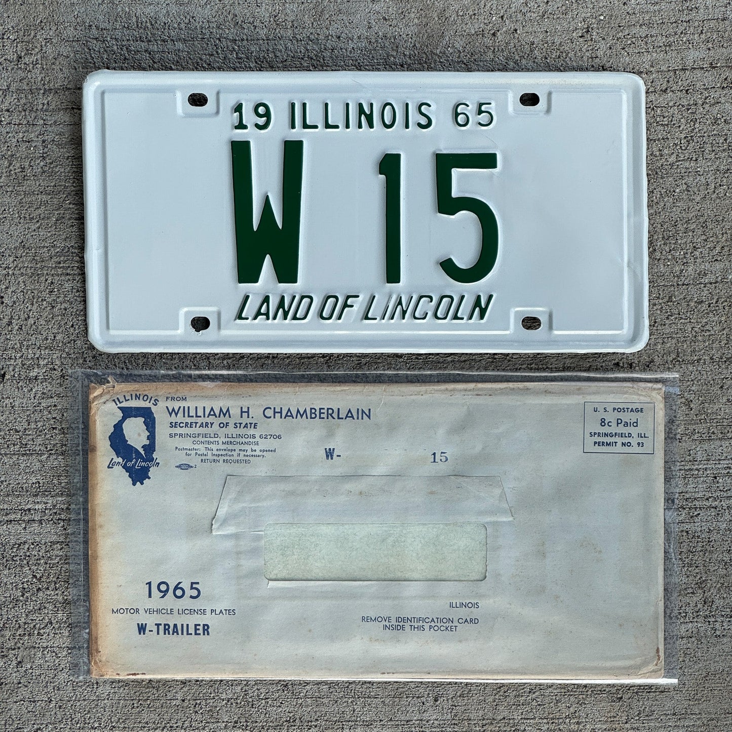 Photo of a 1965 Illinois Trailer License Plate Auto Tag Garage Decor Vintage Low Number Two Digit with Envelope W 15 with original patina