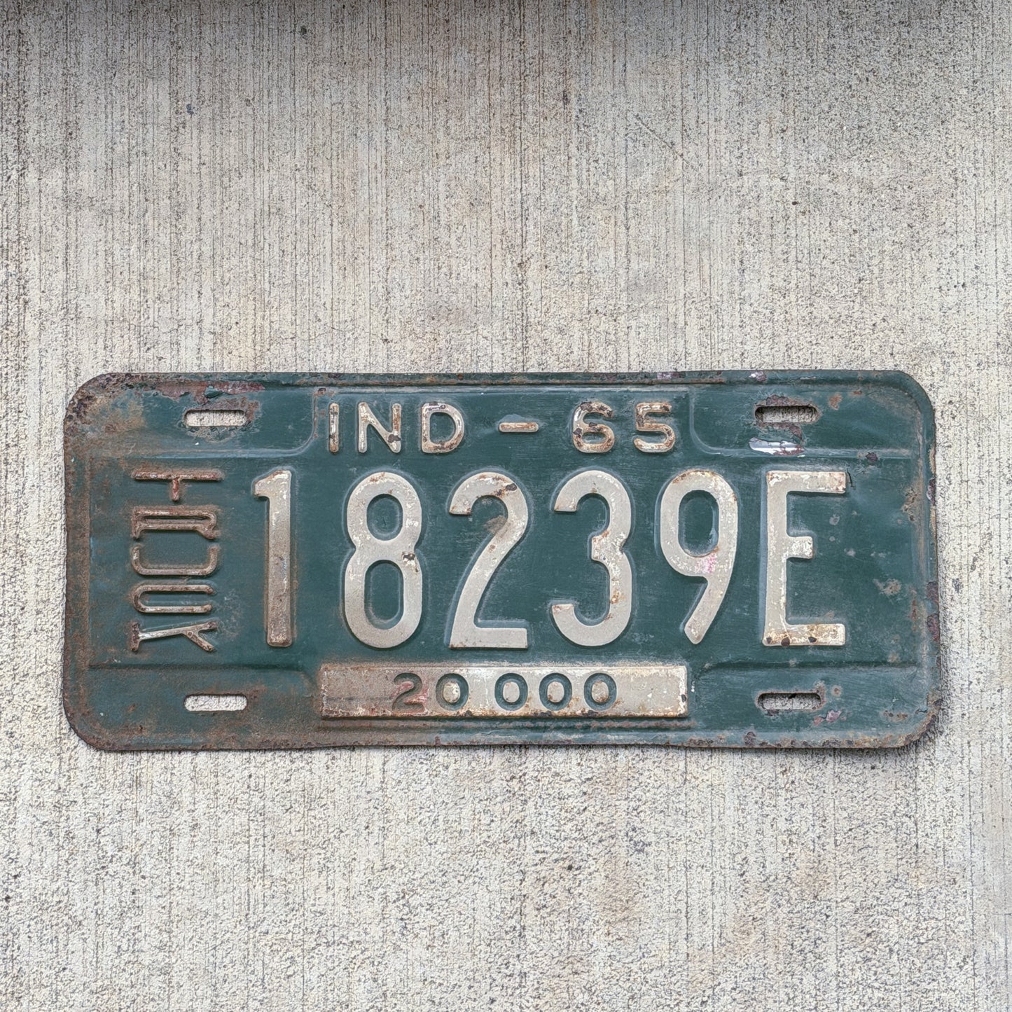 Photo of a 1965 Indiana Truck License Plate Auto Tag Garage Decor Vintage 18239 E with original patina