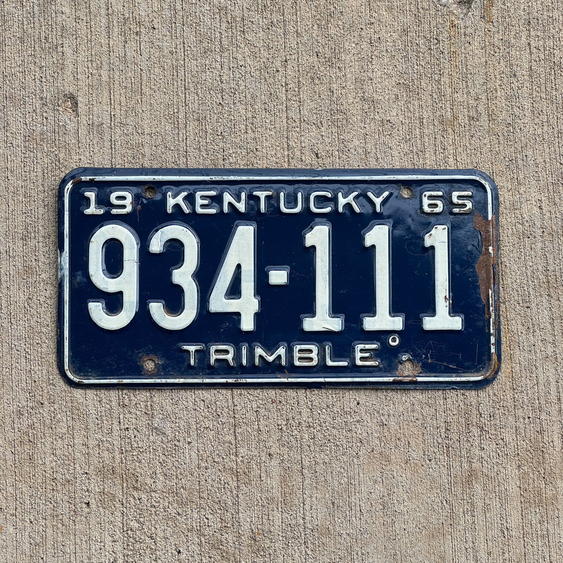 Photo of a 1965 Kentucky License Plate Auto Tag Garage Decor Vintage Repeat Repeating 934 111 with original patina