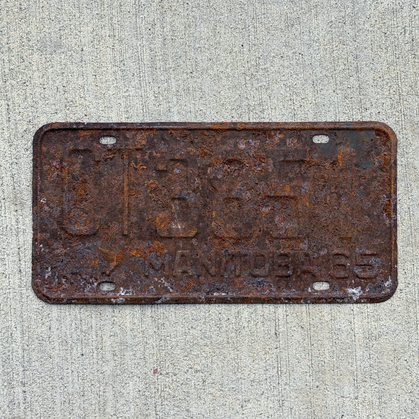Photo of a 1965 Manitoba Commercial License Plate Auto Tag Garage Decor Vintage CT 3851 with original patina