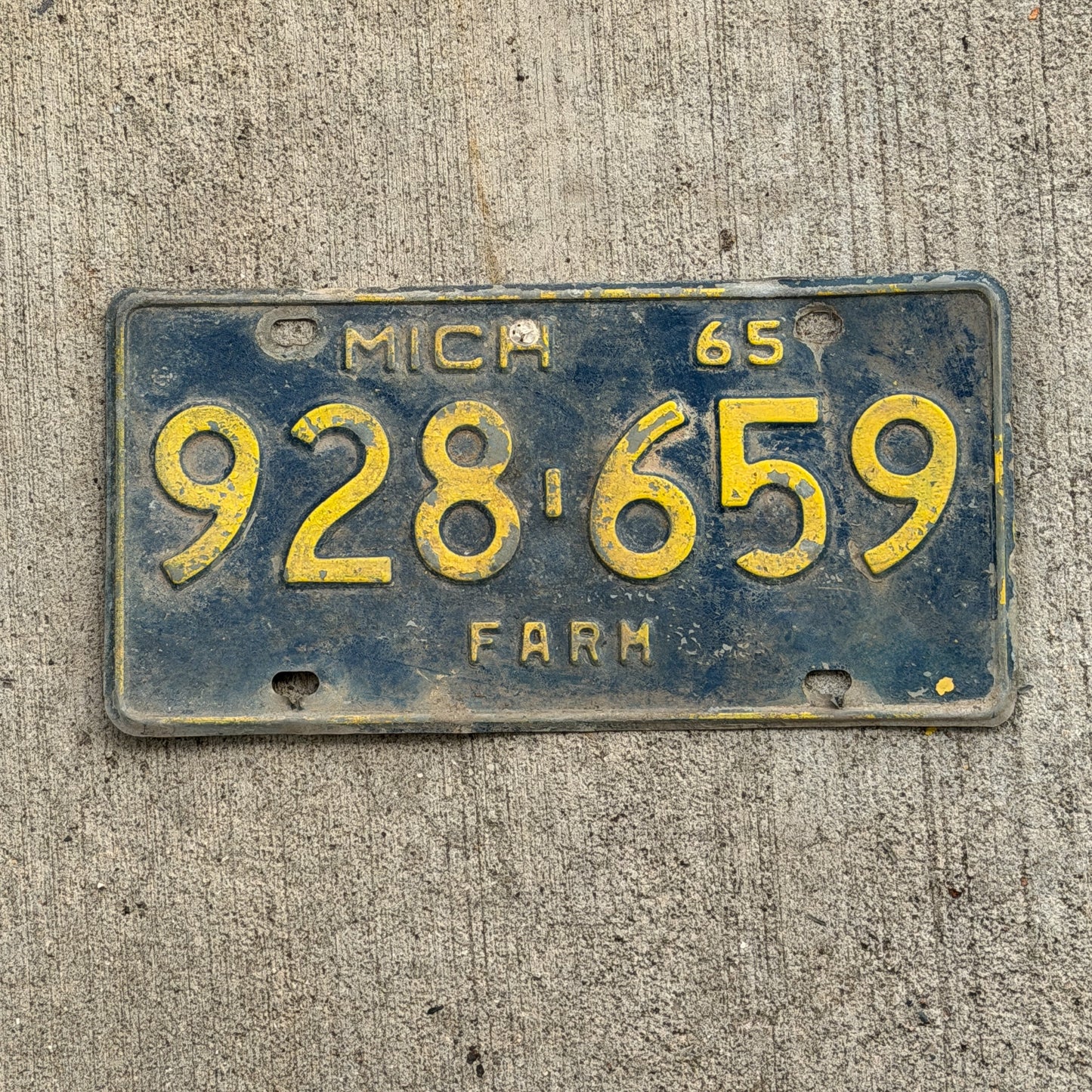 Photo of a 1965 Michigan Farm License Plate Auto Tag Garage Decor Vintage 928 659 with original patina