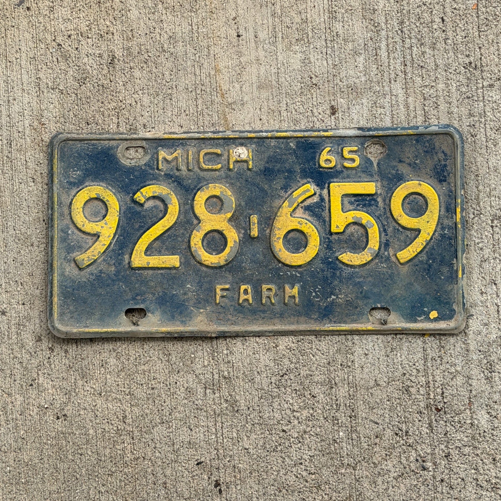 Photo of a 1965 Michigan Farm License Plate Auto Tag Garage Decor Vintage 928 659 with original patina