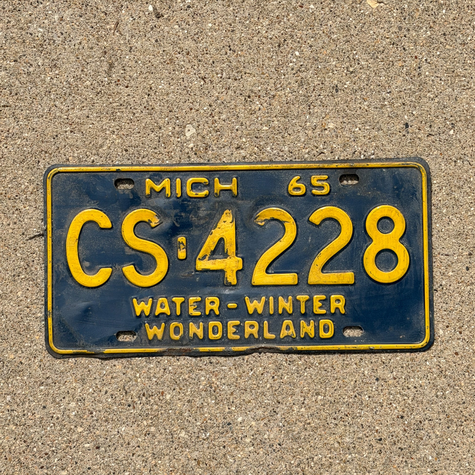 Photo of a 1965 Michigan License Plate Auto Tag Garage Decor Vintage CS 4228 with original patina