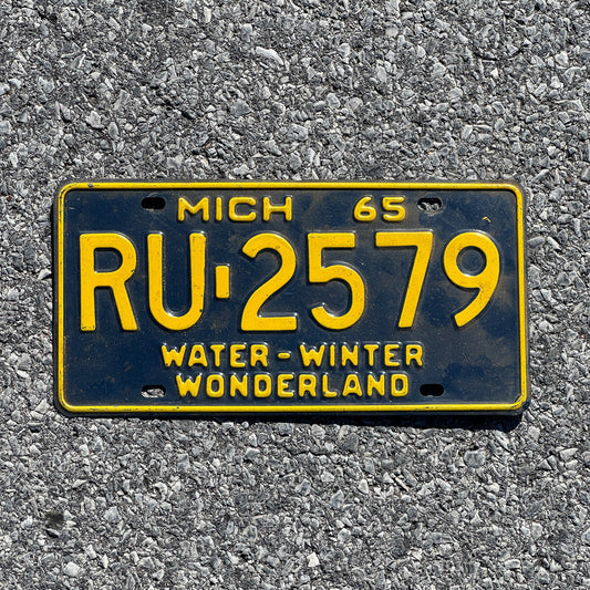 Photo of a 1965 Michigan License Plate Auto Tag Garage Decor Vintage RU 2579