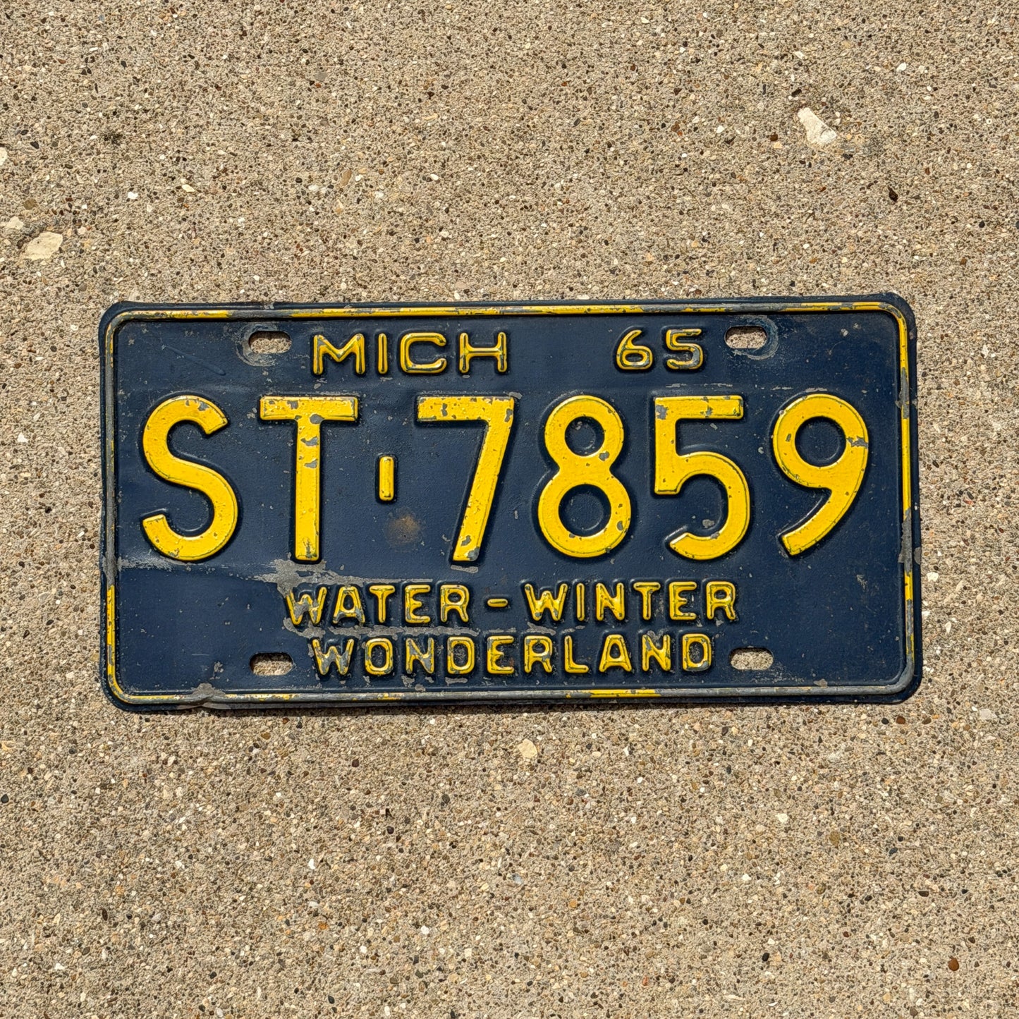 Photo of a 1965 Michigan License Plate Auto Tag Garage Decor Vintage ST 7859 with original patina