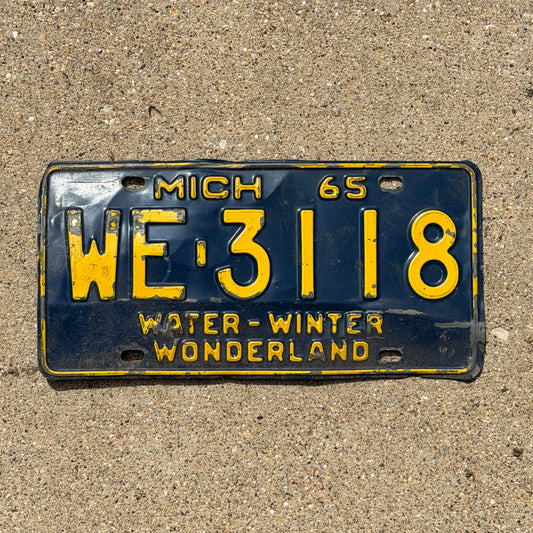 Photo of a 1965 Michigan License Plate Auto Tag Garage Decor Vintage WE 3118 with original patina