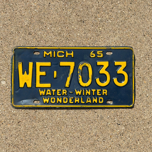 Photo of a 1965 Michigan License Plate Auto Tag Garage Decor Vintage WE 7033 with original patina