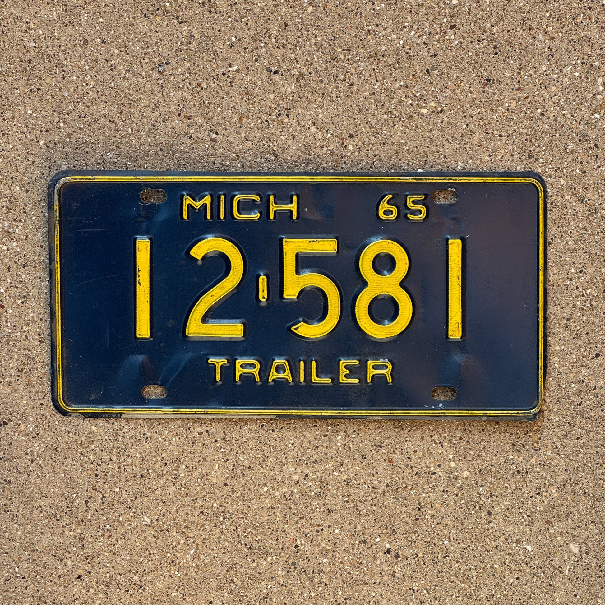 Photo of a 1965 Michigan Trailer License Plate Auto Tag Garage Decor Vintage 12 581