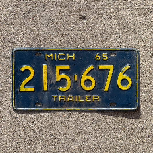 Photo of a 1965 Michigan Trailer License Plate Auto Tag Garage Decor Vintage 215 676 with original patina