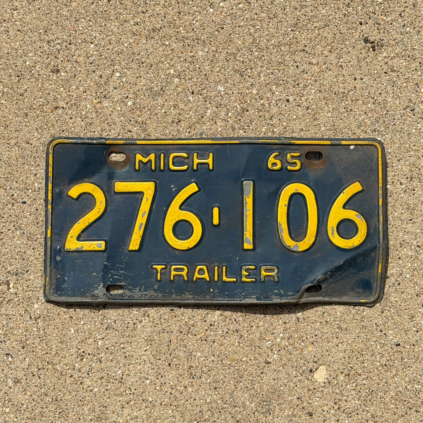 Photo of a 1965 Michigan Trailer License Plate Auto Tag Garage Decor Vintage 276 106 with original patina