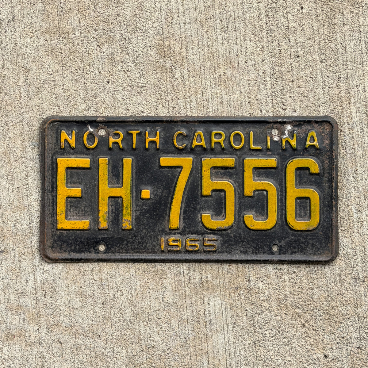 Photo of a 1965 North Carolina License Plate Auto Tag Garage Decor Vintage EH 7556 with original patina
