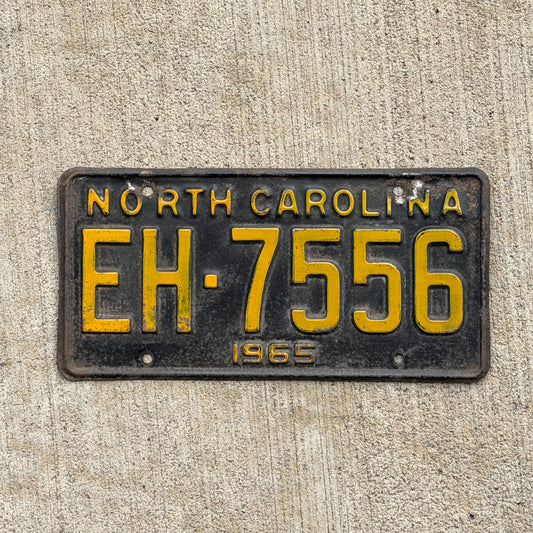 Photo of a 1965 North Carolina License Plate Auto Tag Garage Decor Vintage EH 7556 with original patina