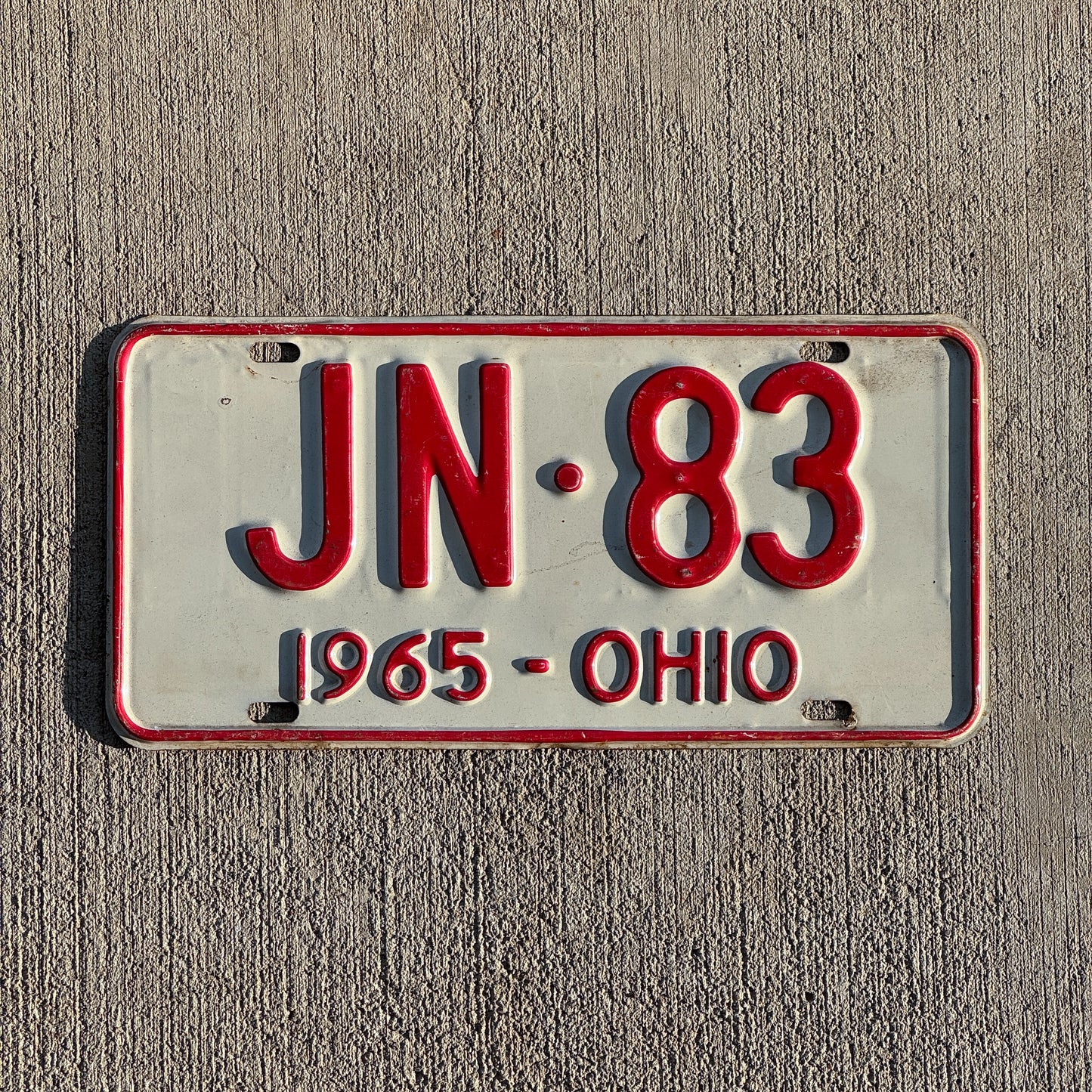 Photo of a 1965 Ohio License Plate Auto Tag Garage Decor Vintage JN 83 with original patina