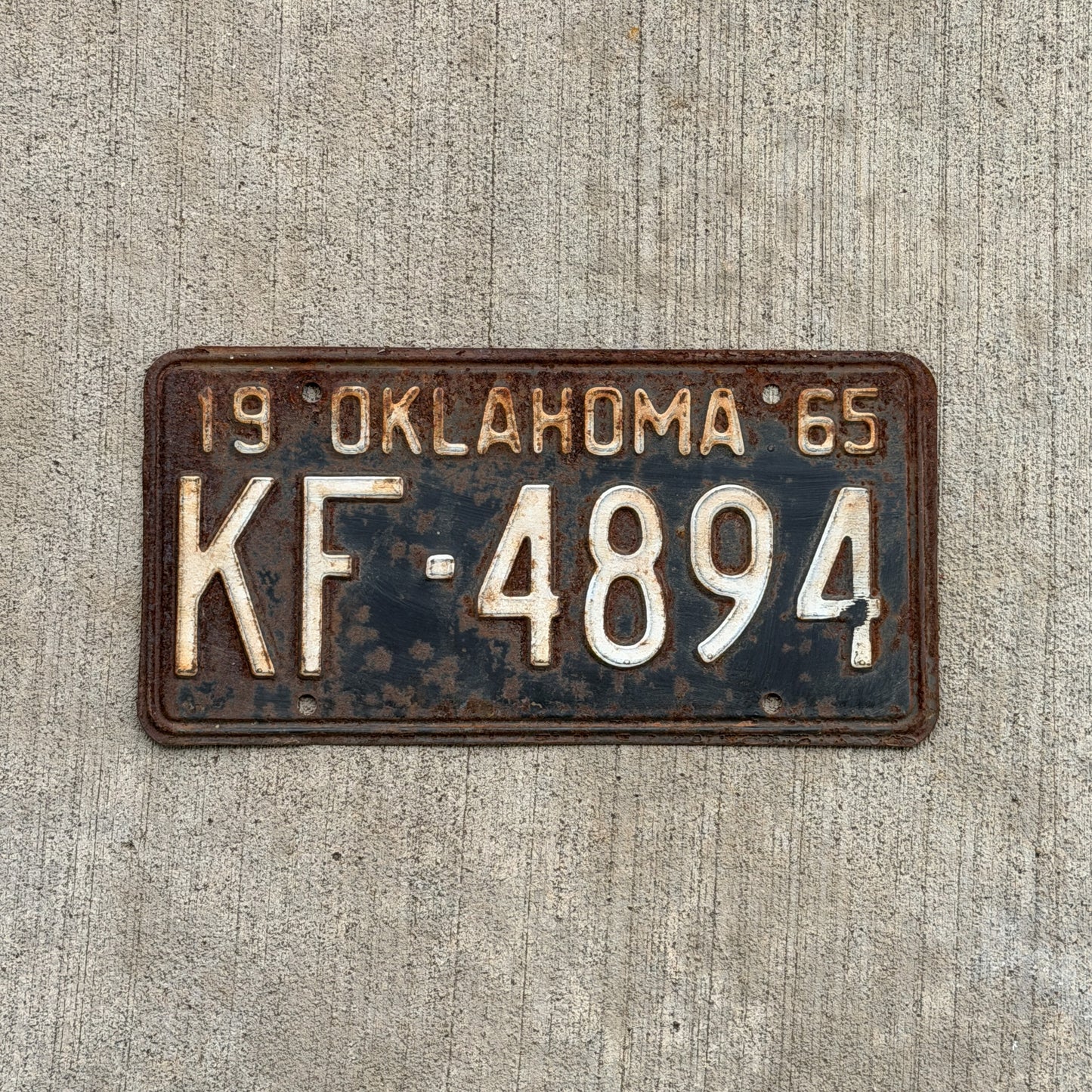 Photo of a 1965 Oklahoma License Plate Auto Tag Garage Decor Vintage KF 4894 with original patina