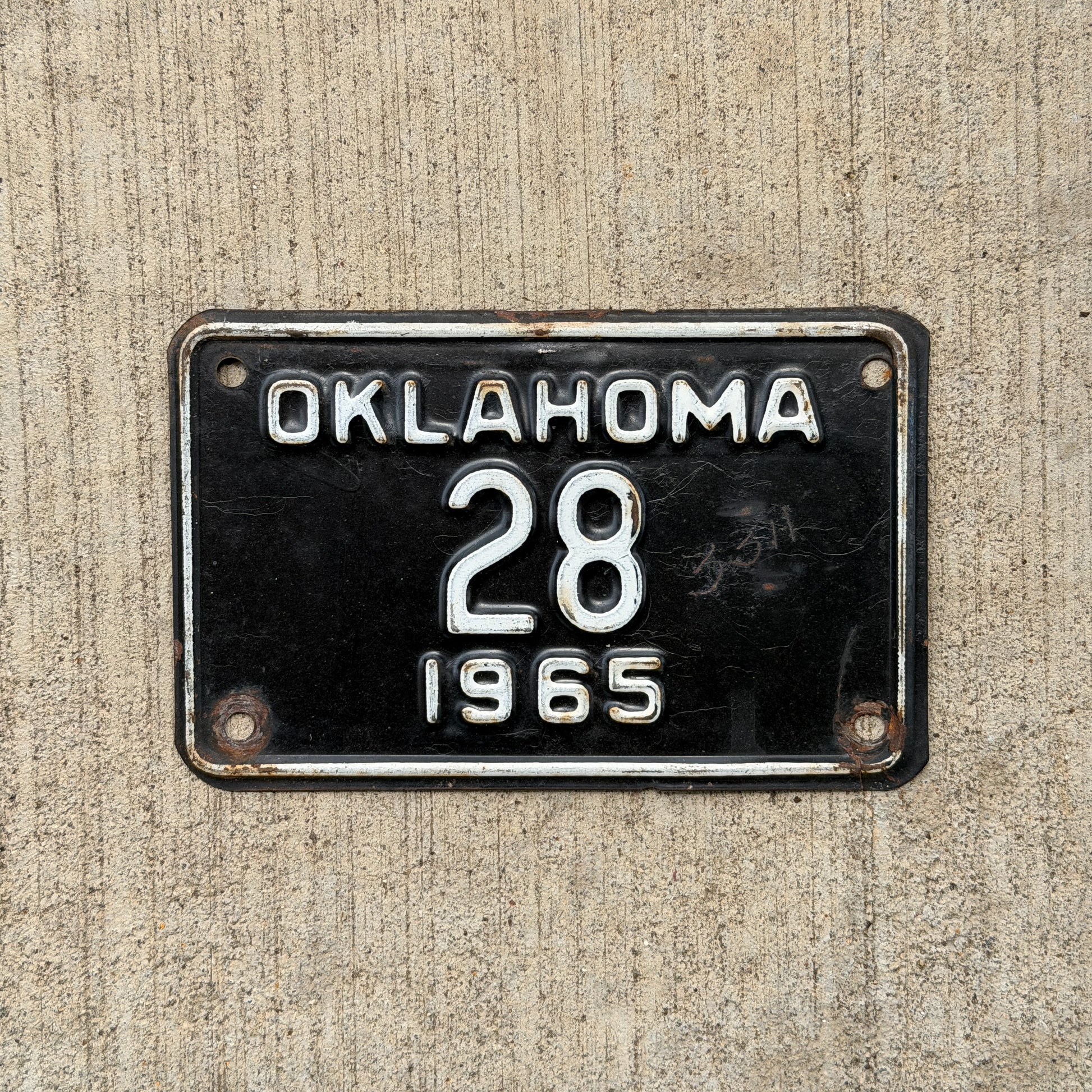Photo of a 1965 Oklahoma Police Motorcycle License Plate Auto Tag Garage Decor Vintage Low Number Two Digit OKC Cop 28 with original patina