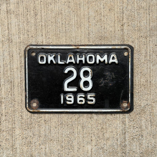 Photo of a 1965 Oklahoma Police Motorcycle License Plate Auto Tag Garage Decor Vintage Low Number Two Digit OKC Cop 28 with original patina