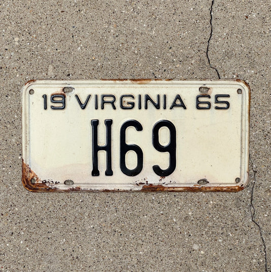 Photo of a 1965 Virginia Taxi Cab License Plate Auto Tag 1 Vintage Garage Low Number Two Digit H 69 with original patina