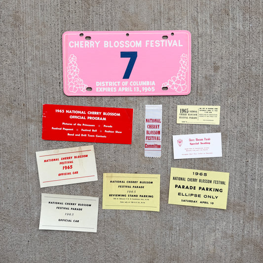 Photo of a 1965 Washington DC Cherry Blossom Festival License Plate Auto Tag Garage Decor Vintage Low Number Single Digit 7 with original patina