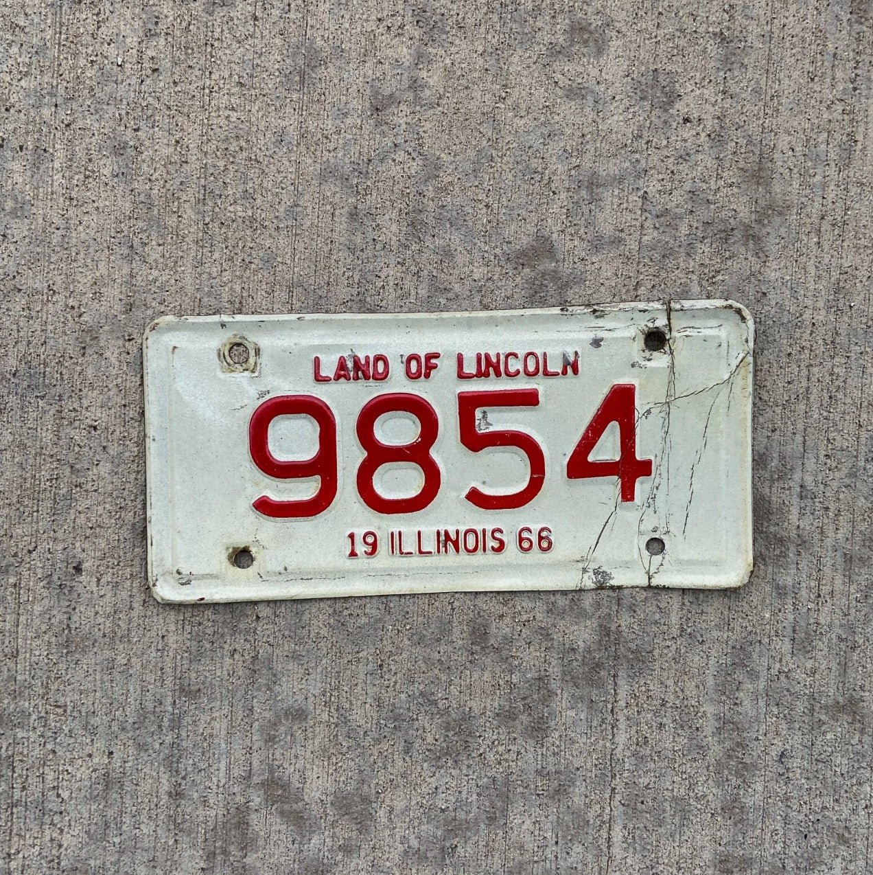 Photo of a 1966 Illinois Motorcycle License Plate Auto Tag Garage Decor Vintage Low Number Four Digit 9854 with original patina