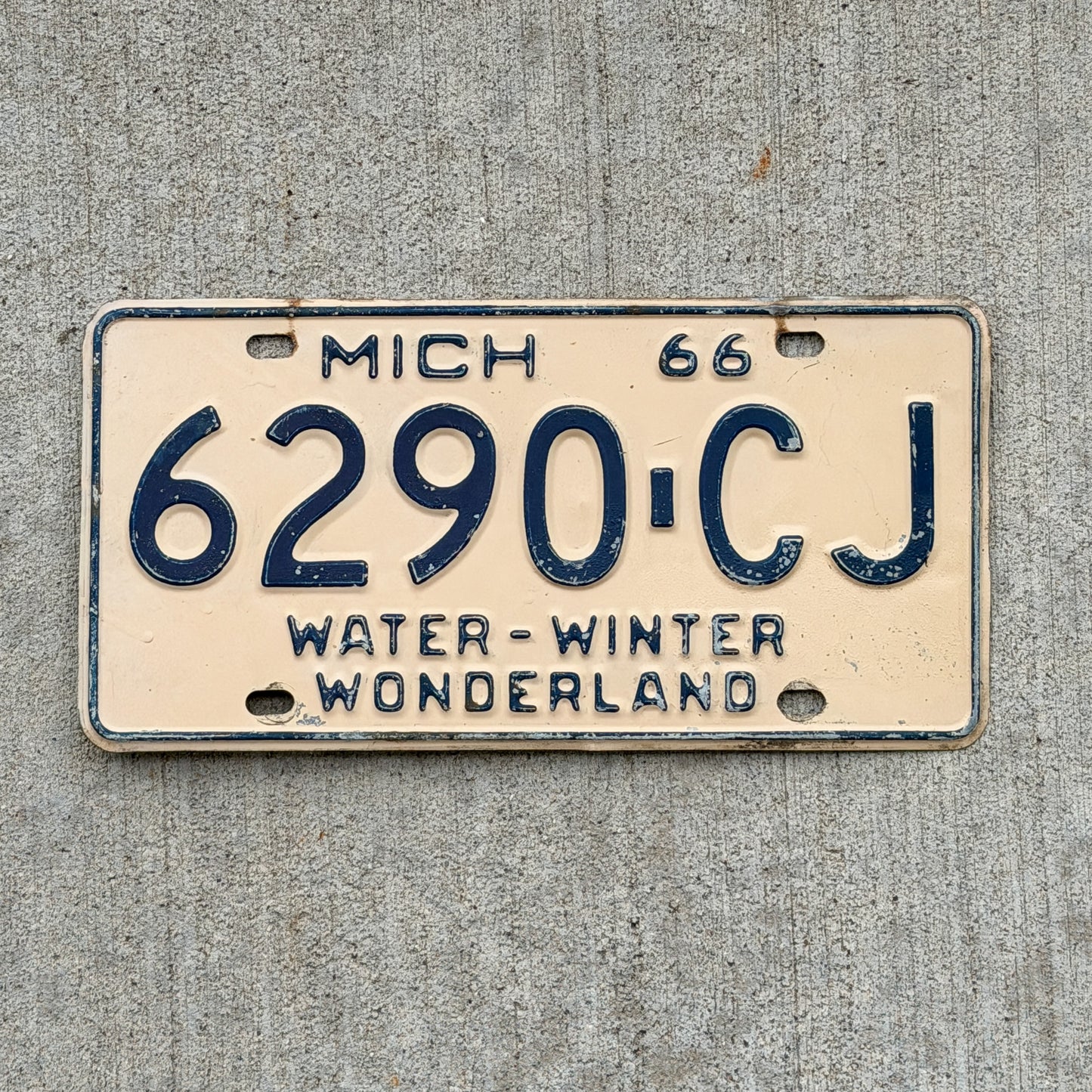 Photo of a 1966 Michigan Commercial License Plate Auto Tag Garage Decor Vintage 6290 CJ with original patina