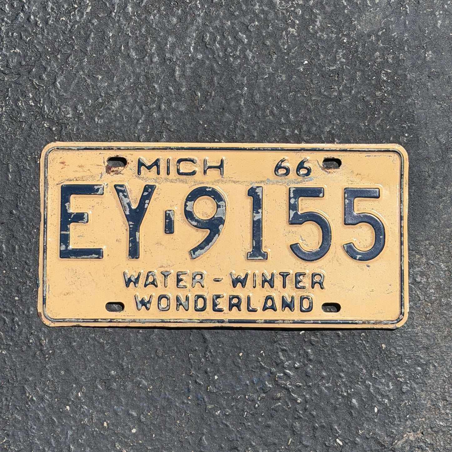 Photo of a 1966 Michigan License Plate Auto Tag Garage Decor Vintage EY 9155 with original patina