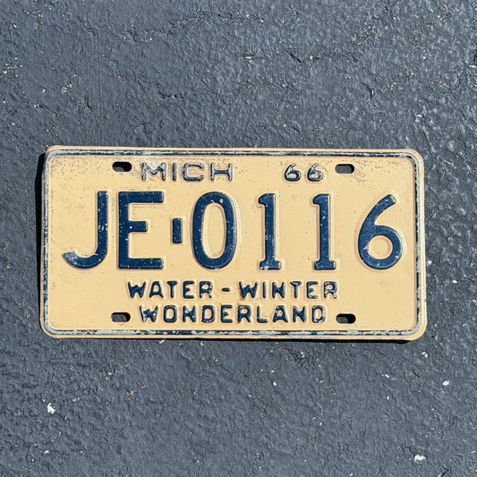Photo of a 1966 Michigan License Plate Auto Tag Garage Decor Vintage JE 0116 with original patina