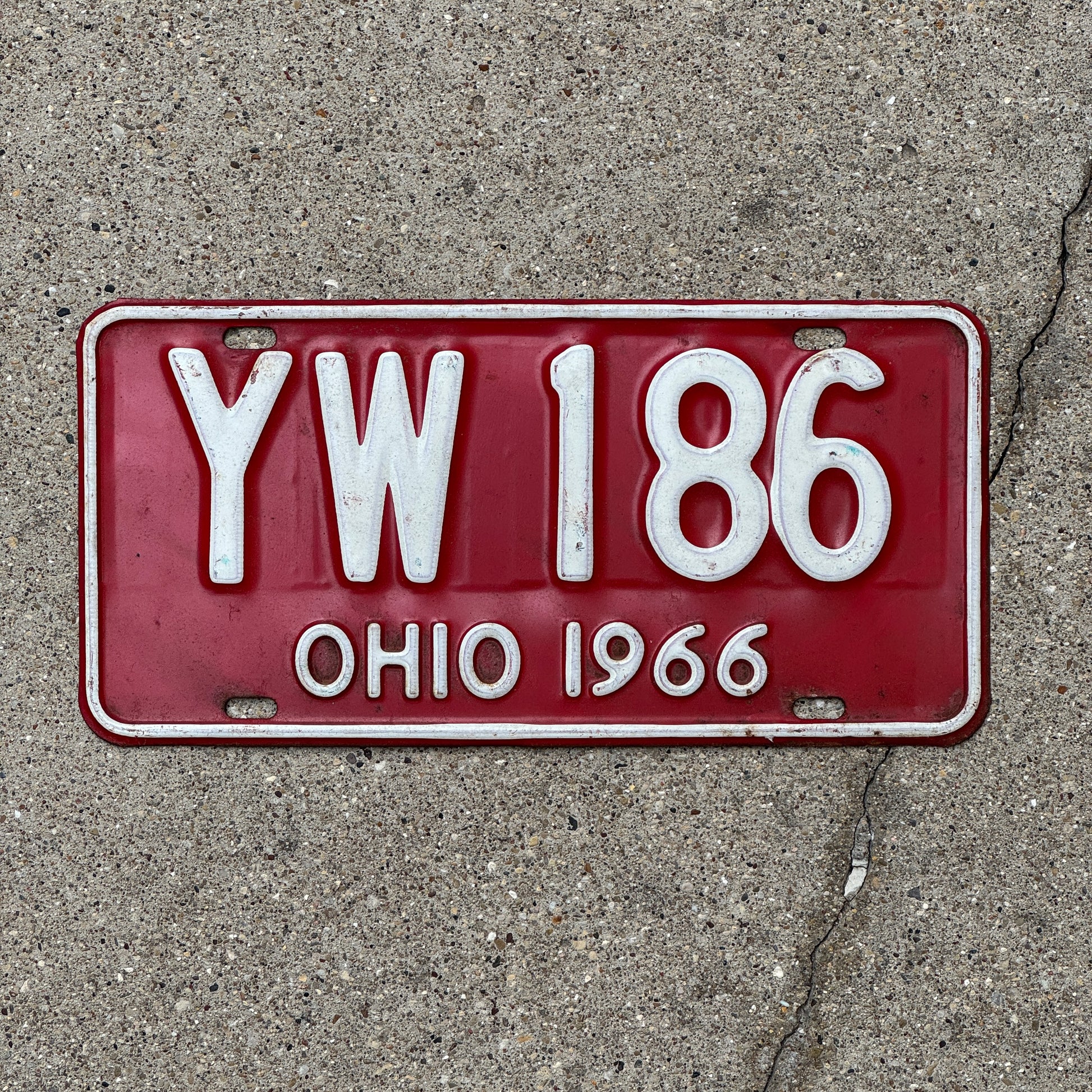 Photo of a 1966 Ohio License Plate Auto Tag 2 Vintage Garage YW 186 with original patina