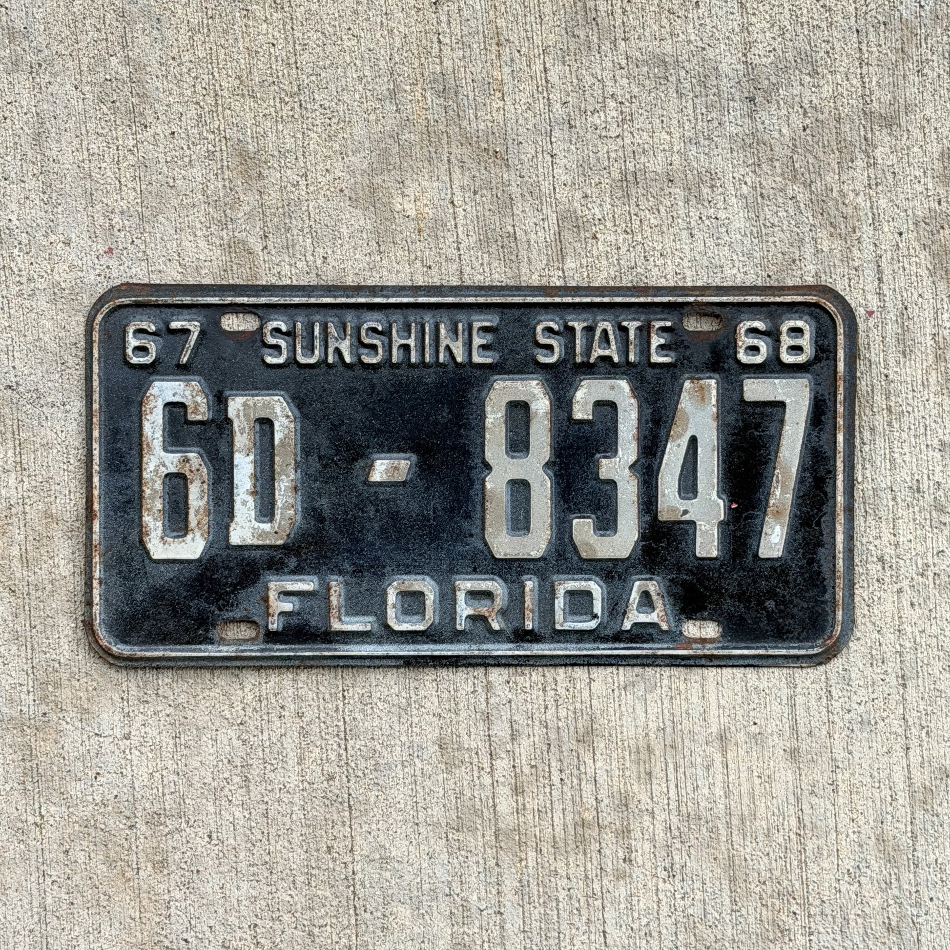 Photo of a 1967 1968 Florida License Plate Auto Tag Garage Decor Vintage YOM DMV Clear Number 6D 8347 with original patina
