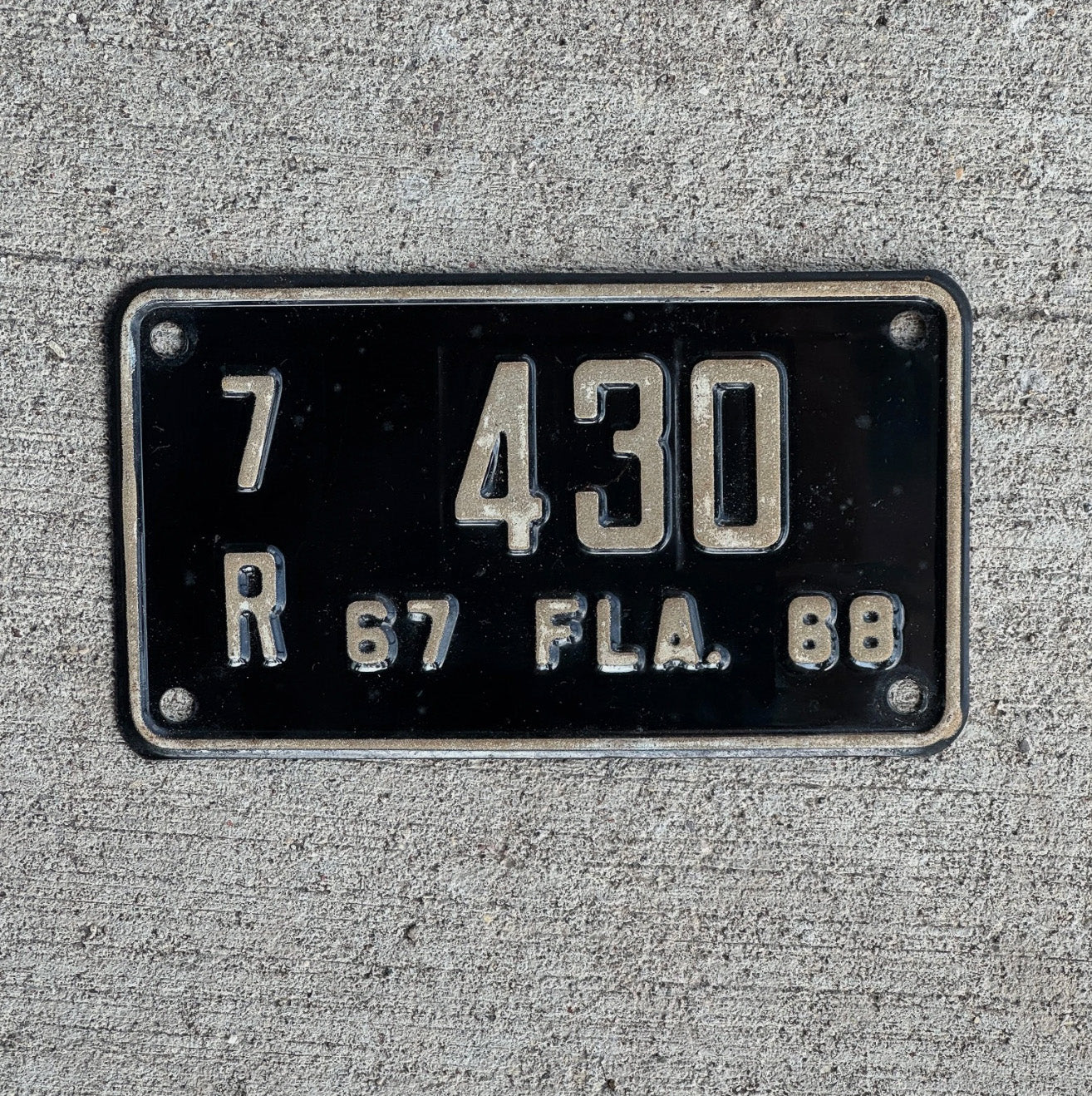 Photo of a 1967 1968 Florida Motorcycle License Plate Auto Tag Garage Decor Vintage Orange County 7R 430 with original patina