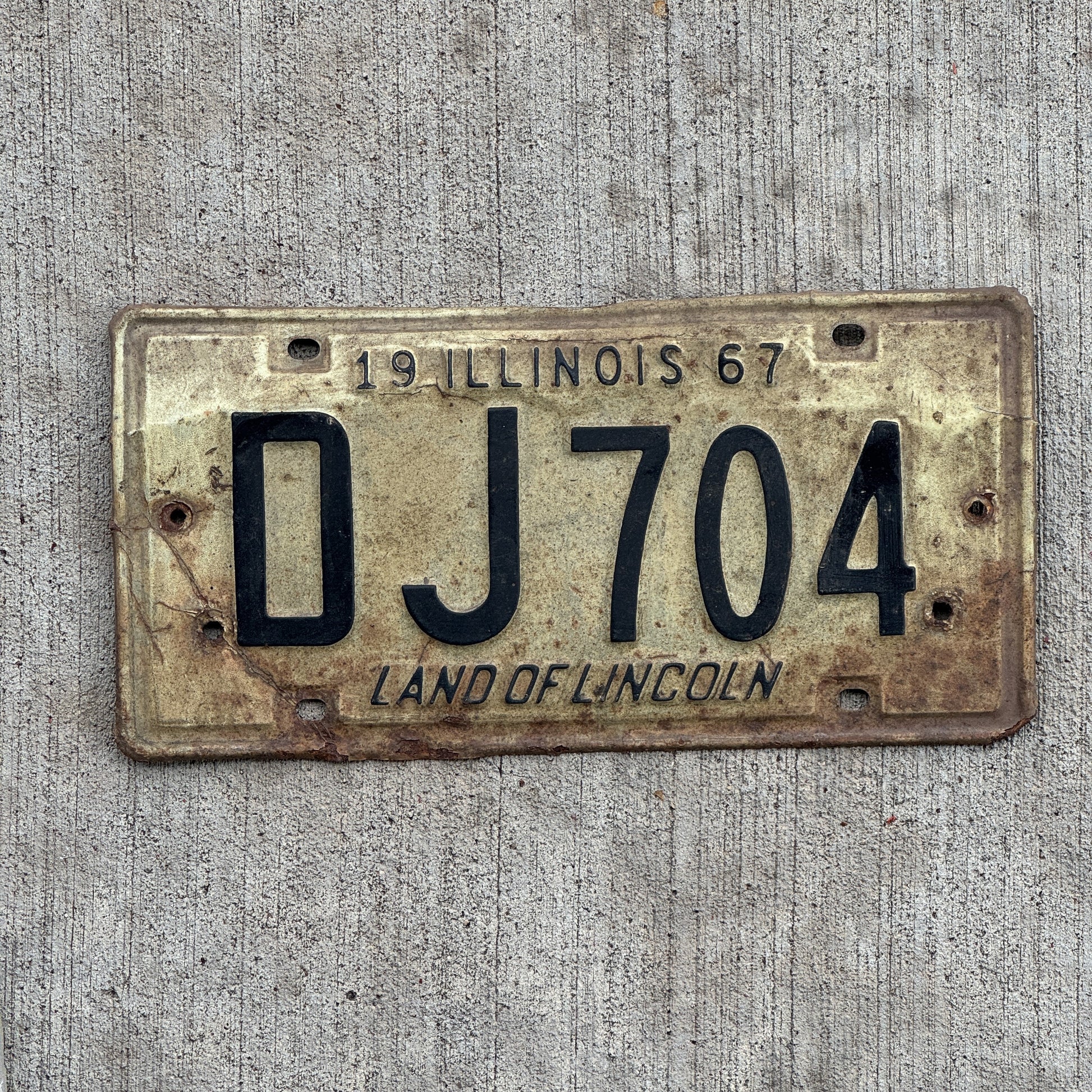 Photo of a 1967 Illinois License Plate Auto Tag 2 Vintage Garage DJ 704 with original patina