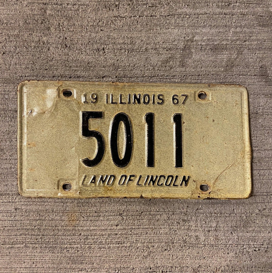 Photo of a 1967 Illinois License Plate Auto Tag Garage Decor Vintage Low Number Four Digit 5011 with original patina