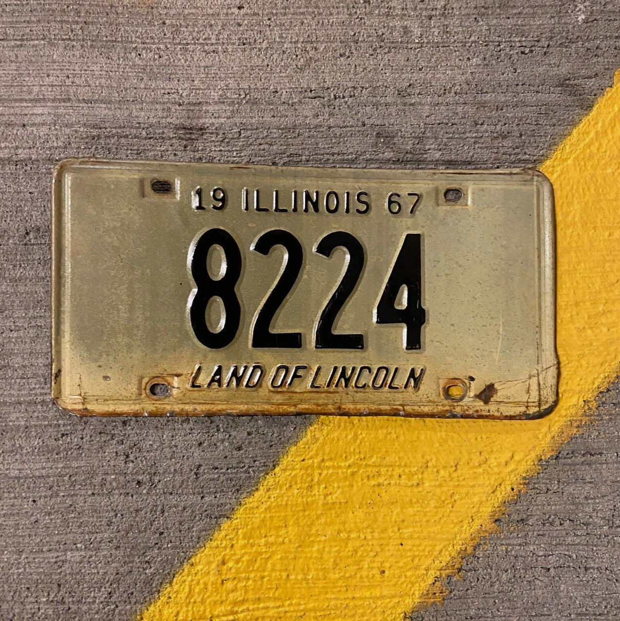 Photo of a 1967 Illinois License Plate Auto Tag Garage Decor Vintage Low Number Four Digit 8224 with original patina
