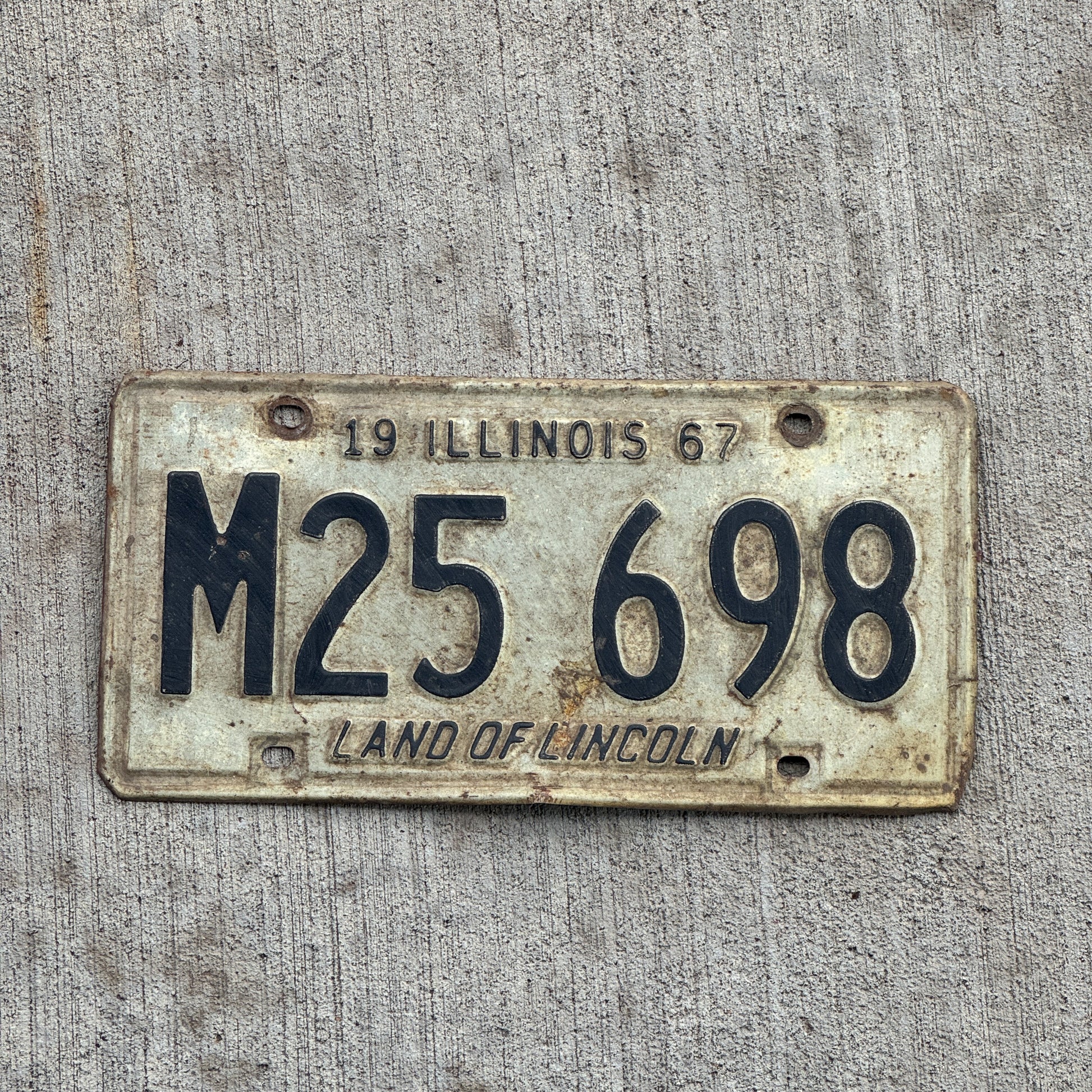 Photo of a 1967 Illinois Municipal License Plate Auto Tag 2 Vintage Garage M 25 698 with original patina