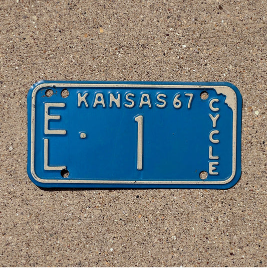 Photo of a 1967 Kansas Motorcycle License Plate Auto Tag Garage Decor Vintage Low Number Single Digit Ellis County EL 1 with original patina