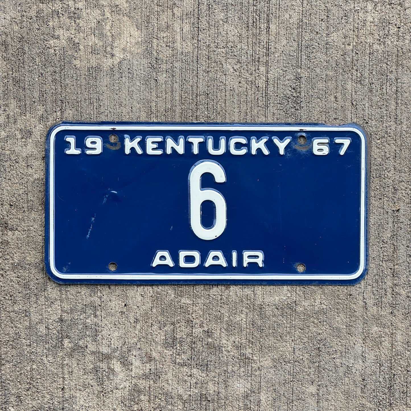 Photo of a 1967 Kentucky License Plate Auto Tag Garage Decor Vintage Adair County Low Number Single Digit 6 with original patina