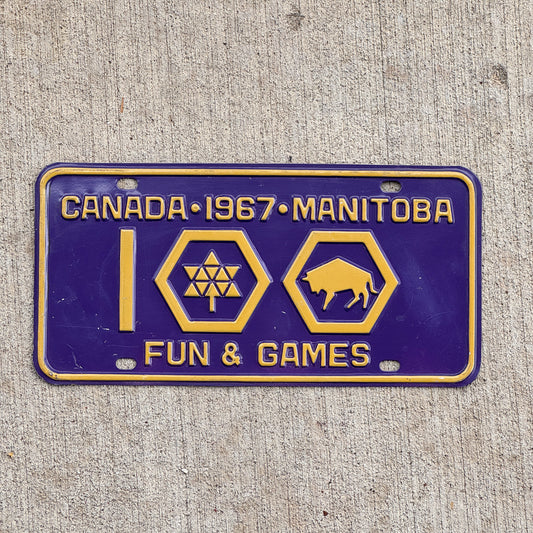 Photo of a 1967 Manitoba Booster License Plate Auto Tag Garage Decor Vintage Centennial Fun & Games with original patina