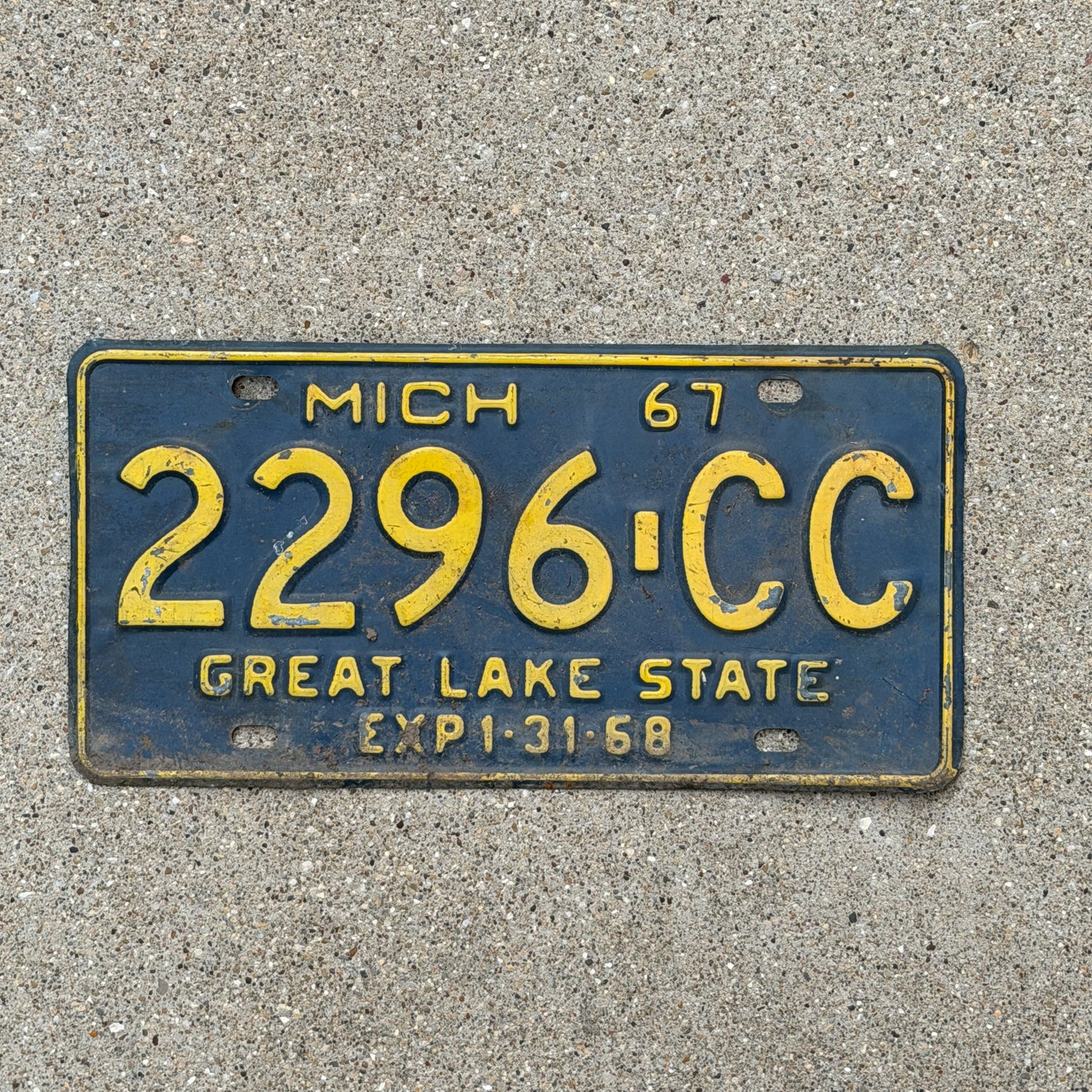 Photo of a 1967 Michigan Commercial License Plate Auto Tag Garage Decor Vintage 2296 CC with original patina