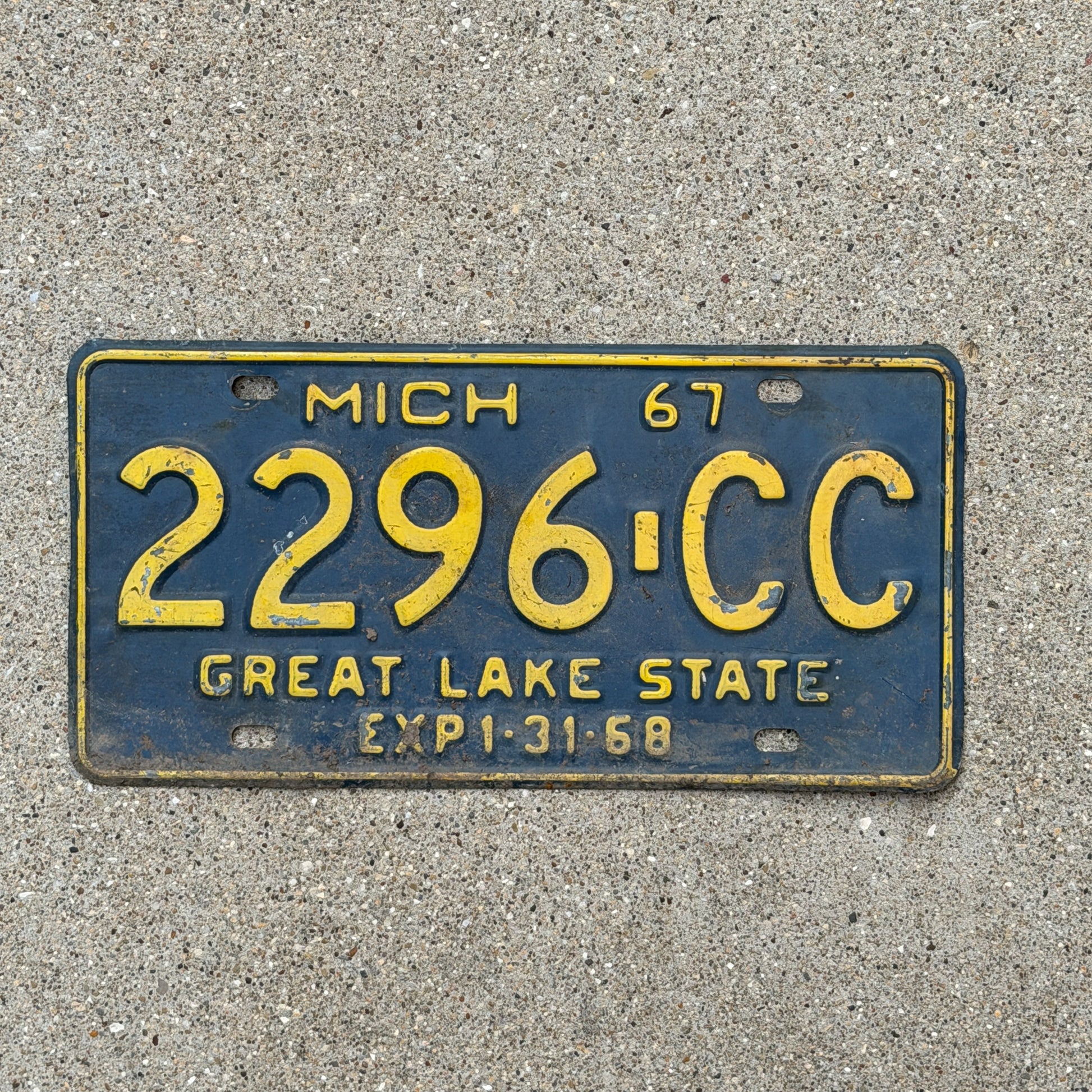 Photo of a 1967 Michigan Commercial License Plate Auto Tag Garage Decor Vintage 2296 CC with original patina